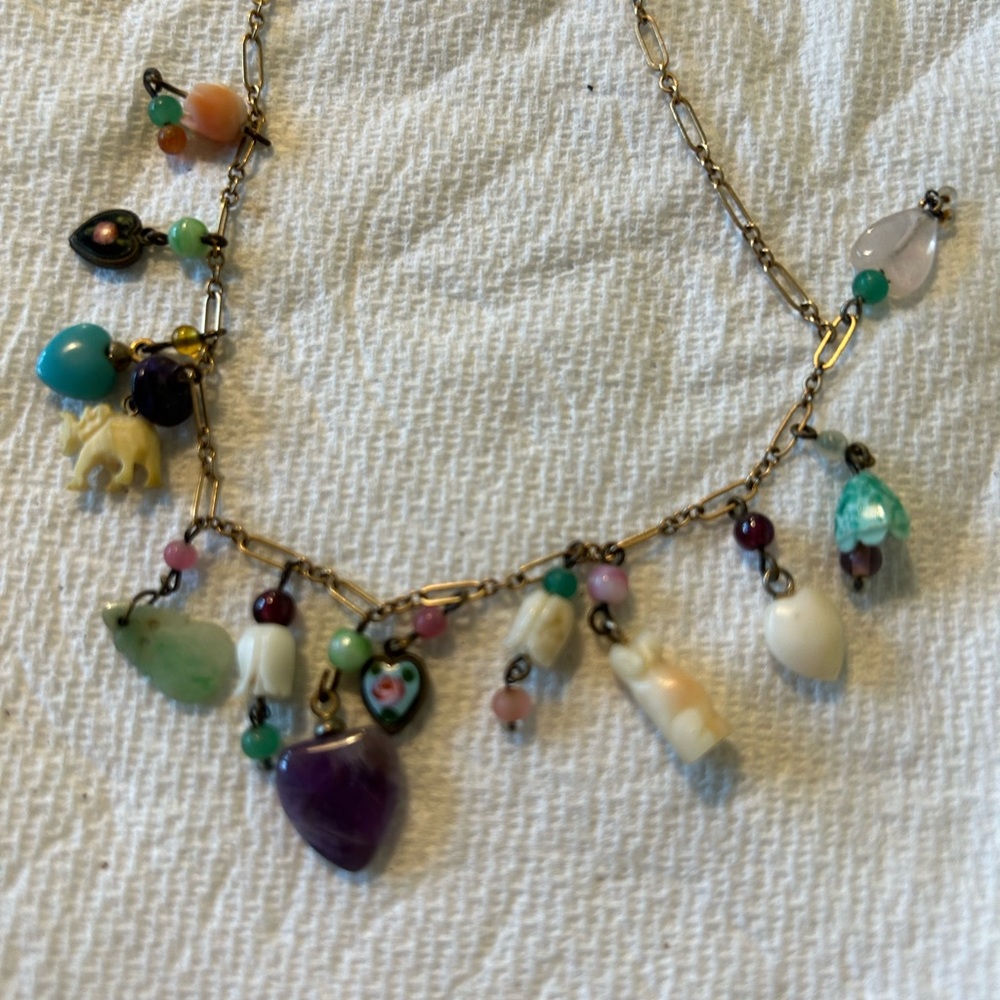 Vintage Lucy Isaac necklace. Charms attached to gold chain.